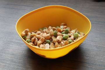Mixed snack nuts, cashew, almonds, green nuts in the little bowl put on wood tray. snack food for coffee break 