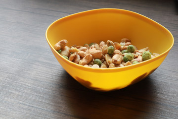 Mixed snack nuts, cashew, almonds, green nuts in the little bowl put on wood tray. snack food for coffee break 