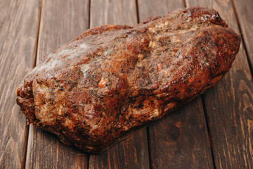 whole pork sausage on a wooden background. without label. space for text