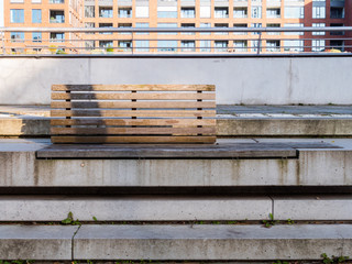 A wooden bench on a concrete stair in Hafencity district in Hamburg.