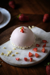 Strawberry Mousse Domes cake. set on cafe table.