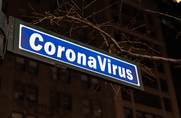 Street sign with coronavirus word in New York City, USA.NY lockdown caused by coronavirus or...