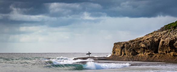 surfer contemplating the ocean