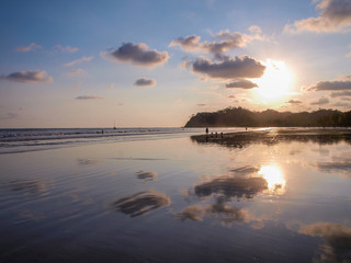 The sun reflecting on the water of Sámara beach at sunset, Costa Rica