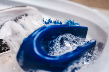 washing shoes with bubbles and brush