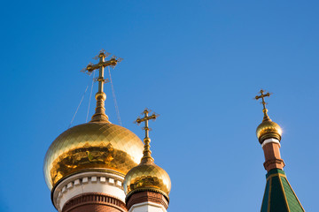 Fototapeta na wymiar Three domes of the Orthodox Church against the blue sky. Religious building. architecture.