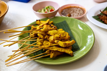 Chicken satay over restaurant table in Thailand