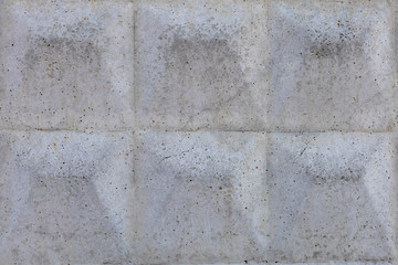 Background texture of an old gray concrete fence with a square close-up pattern.Backgrounds and textures