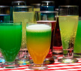 Glasses with a cocktail. Multicolored drinks. Drunk party.