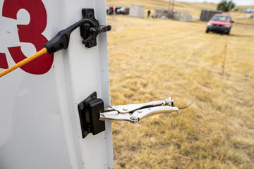 Vice grips on a vehicle door to help eod bomb technicians open it remotely