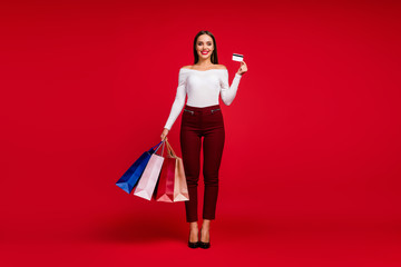 Full size photo elegant stunning trend girl lady shopping center client buy hold bags purchases enjoy pay debit card wear white checkered trousers shoes isolated bright shine color background