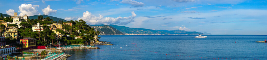 Fototapeta na wymiar Scenic view of Santa Margherita Ligure on the Italian Riviera overlooking the Gulf of Tigullio. Beautiful mediterranean landscape with cloudy blue sky on sunny day.