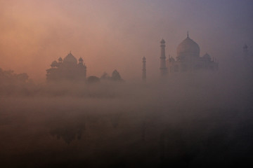 View of Taj Mahal reflected in Yamuna river with early morning fog, Agra, Uttar Pradesh, India