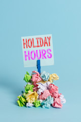 Writing note showing Holiday Hours. Business concept for Overtime work on for employees under...