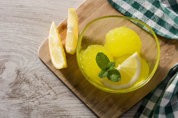 Lemon sorbet in glasses on wooden table