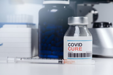 Coronavirus COVID-19 vaccine glass bottle in the laboratory. Cure for coronavirus. Chinese corona virus blood test concept.