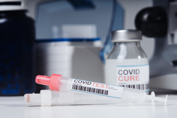 Coronavirus COVID-19 vaccine glass bottle in the laboratory. Cure for coronavirus un a test tube. Blood test tube for 2019 nCoV analysis. Chinese corona virus blood test concept.