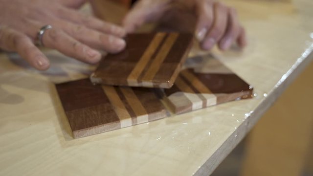 Carpenter oiling wooden board
