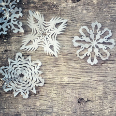 Snowflakes border on grunge wooden background