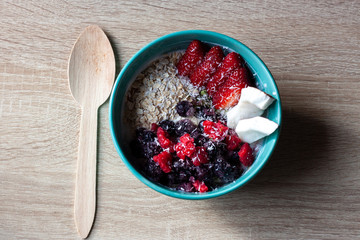 Healthy smoothie bowl with granola, fresh strawberries, blueberries, coconut, yogurt and chia seeds. Healthy food, snack or breakfast.