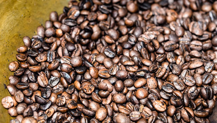Roasting coffee bean in brass pan