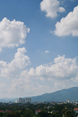 white cloud on clear blue sky above the town