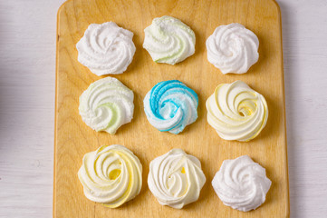 Homemade sweet colored meringue on wooden background.  .Dessert. Top view.
