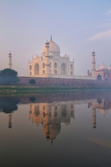 View of Taj Mahal with early morning fog reflected in Yamuna River, Agra, Uttar Pradesh, India