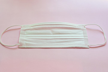 medical hygiene face mask on pink background