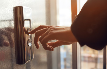 Finger presses the elevator button. Businessman pushing up elevator button. Human hand reaches for the button of the elevator call.
