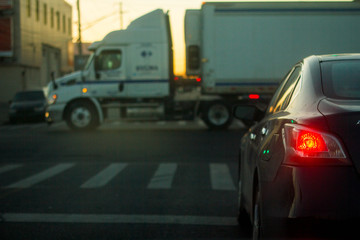 Car waiting for trailer to pass