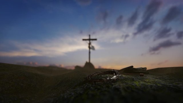 Crucifixion of Jesus Christ with thorn crown, nails, hammer and a rope against beautiful sunrise