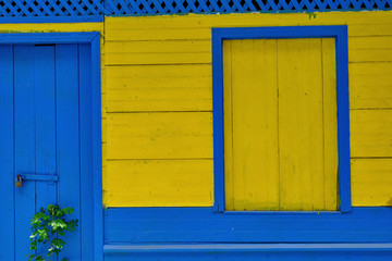 Fototapeta na wymiar Colorful wooden old building door and window in Paquera Costa Rica