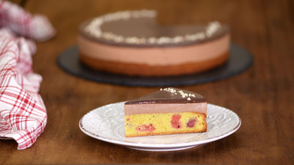 Piece of Chocolate Cherry Mousse Cake on a plate.