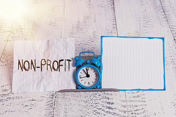 Conceptual hand writing showing Non Profit. Concept meaning type of organization that does not earn...