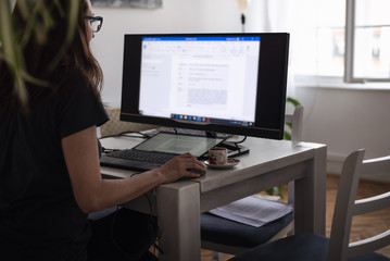 Fototapeta premium Woman working on computer from home. Busy people lifestyle.