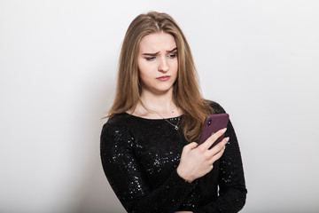 portrait of upset woman watching smartphone display