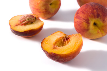 Fototapeta na wymiar Pieces of peach fruit isolated on white background
