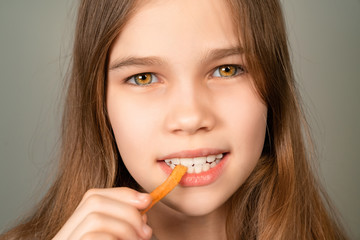 teenage girl eating French fries closeup. 