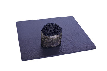 Traditional fresh japanese sushi on black stone Tobika night on a white background. Gunkan...