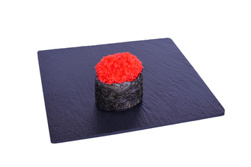 Traditional fresh japanese sushi on black stone Tobik Red on a white background. Gunkan ingredients: chaplain caviar, nori, rice.