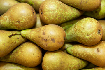 Nicely arranged in rows juicy green pears on the counter. Close-up. View from above.