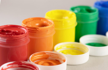 Colorful vibrant cans of gouache isolated on white