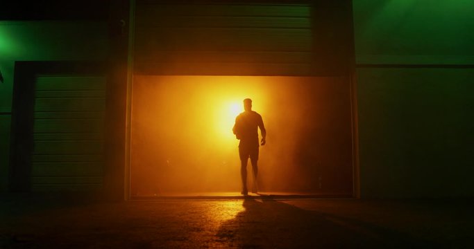 Man working out in dark gym