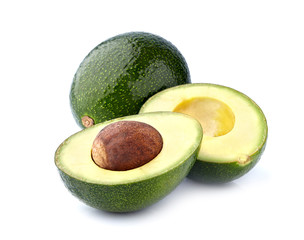 Whole green avocado  with half isolated on white background