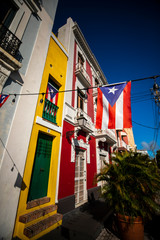 The Puerto Rican flag flies on a sunny day in the colorful Viejo San Juan, Puerto Rico.