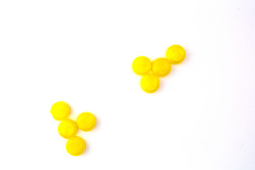 yellow pills on white background