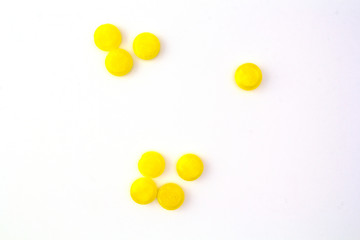 yellow pills on white background