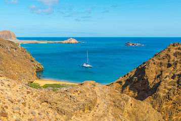 An anchored catamaran sailing boat seen from Punta Pitt on San Cristobal island, Galapagos,...