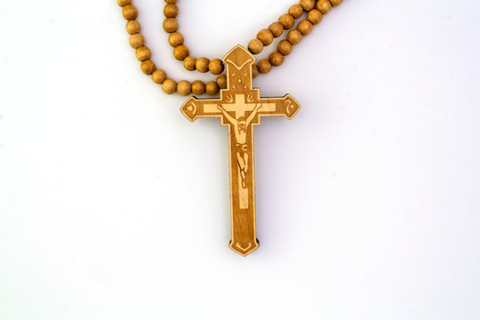 Crucifix necklace  The top has a light brown Jesus on a white background.